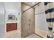 Walk-in shower area with a modern tile design and hardware at 6062 Spinnaker Blvd, Englewood, FL 34224