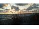 Beautiful beach sunrise with dune grass in the foreground creating a scenic vista at 6062 Spinnaker Blvd, Englewood, FL 34224
