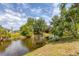 Scenic view of canal lined with lush tropical foliage and trees at 6062 Spinnaker Blvd, Englewood, FL 34224