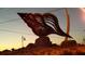 Oversized conch shell sculpture on a hill at sunset, a striking landmark at 6062 Spinnaker Blvd, Englewood, FL 34224