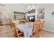 Open-concept dining area with kitchen views, a large table, and a ceiling fan at 6062 Spinnaker Blvd, Englewood, FL 34224