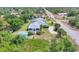 Beautiful aerial view of a single-story home with a screened pool and lush landscaping at 6062 Spinnaker Blvd, Englewood, FL 34224