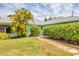 Nice landscaping, palm trees and greenery complement this home's exterior at 6062 Spinnaker Blvd, Englewood, FL 34224