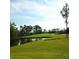 Panoramic view of a lush green golf course with a tranquil lake at 6062 Spinnaker Blvd, Englewood, FL 34224