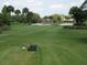 Beautiful golf course view with lush green grass and surrounding trees at 6062 Spinnaker Blvd, Englewood, FL 34224