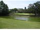 Gorgeous golf course featuring a serene pond, pristine greens, and lush trees at 6062 Spinnaker Blvd, Englewood, FL 34224