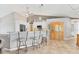 Bright kitchen boasts stainless appliances, breakfast bar with seating, and custom backsplash at 6062 Spinnaker Blvd, Englewood, FL 34224