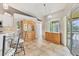 Open-concept kitchen with breakfast bar, hutch, and sliding doors to outdoor lanai at 6062 Spinnaker Blvd, Englewood, FL 34224