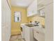 Spacious laundry room features a washer, dryer, utility sink and ample storage space at 6062 Spinnaker Blvd, Englewood, FL 34224