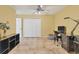Office space features a ceiling fan, tile floors, a large closet, and desk area at 6062 Spinnaker Blvd, Englewood, FL 34224