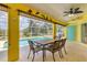 Screened outdoor patio with dining table overlooking pool at 6062 Spinnaker Blvd, Englewood, FL 34224
