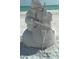 Creative sand sculpture of a snowman musician playing a cello on the beach at 6062 Spinnaker Blvd, Englewood, FL 34224