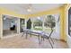 Bright sunroom with tile floors, a dining area with a view of the well-landscaped yard at 6062 Spinnaker Blvd, Englewood, FL 34224