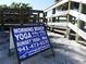 Morning Beach Yoga sign near a sandy beach at 6062 Spinnaker Blvd, Englewood, FL 34224