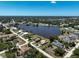 Wide, aerial view of a beautiful lake surrounded by homes with well-maintained landscaping at 6305 Shalimar St, Port Charlotte, FL 33981