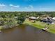 A captivating aerial view showcasing the home's waterfront location and private dock on a serene lake at 6305 Shalimar St, Port Charlotte, FL 33981