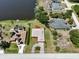 Aerial view of three homes on the lake, each with unique features, including a pool and dock at 6305 Shalimar St, Port Charlotte, FL 33981
