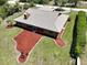 Aerial view of the home showcasing its landscaping and chimney at 6305 Shalimar St, Port Charlotte, FL 33981
