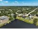 Expansive aerial view of homes in a lakeside community with mature trees and well-maintained streets at 6305 Shalimar St, Port Charlotte, FL 33981