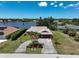 Beautiful aerial view of the home with landscaping and a lake view in a desirable neighborhood at 6305 Shalimar St, Port Charlotte, FL 33981