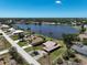 Aerial view of a lakeside home featuring a lake in a quiet residential neighborhood at 6305 Shalimar St, Port Charlotte, FL 33981