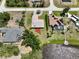 Aerial view of the property shows well maintained homes with a lake, green spaces, and mature trees at 6305 Shalimar St, Port Charlotte, FL 33981