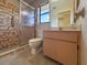 Bathroom featuring a vanity and toilet next to a glass door shower with brown tiles at 6305 Shalimar St, Port Charlotte, FL 33981
