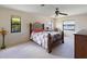Bright bedroom with decorative headboard, ceiling fan, and bright windows with a nice water view at 6305 Shalimar St, Port Charlotte, FL 33981