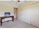 A spacious bedroom with a decorative table with a desktop computer and a sliding door closet at 6305 Shalimar St, Port Charlotte, FL 33981