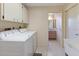 Laundry room featuring a washer, dryer, sink and doorway to a bathroom at 6305 Shalimar St, Port Charlotte, FL 33981