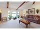 Comfortable living room with vaulted ceilings, exposed beams, and a bay window for natural light at 6305 Shalimar St, Port Charlotte, FL 33981