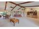 Open-concept living space with vaulted ceilings, exposed beams, and a view of the dining and kitchen areas at 6305 Shalimar St, Port Charlotte, FL 33981