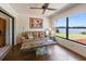 Bright sun room boasts a large window with picturesque views of the tranquil lake and green landscape at 6305 Shalimar St, Port Charlotte, FL 33981