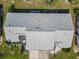 Aerial view showing the roof and backyard with patio furniture of the home and the beautiful landscaping at 667 Foxwood Blvd, Englewood, FL 34223