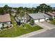 Well-maintained home with a gray roof, lush landscaping, and a welcoming screened entryway at 667 Foxwood Blvd, Englewood, FL 34223