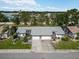 Aerial view showcasing a community featuring well-maintained homes and lush landscapes near local businesses and the US flag at 667 Foxwood Blvd, Englewood, FL 34223