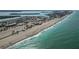 High aerial shot displays a scenic beachfront community with a long sandy shore and clear, turquoise waters at 667 Foxwood Blvd, Englewood, FL 34223