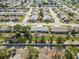 Overview of residential community showing well-maintained single-story homes, streets, green spaces, and manicured lawns at 667 Foxwood Blvd, Englewood, FL 34223