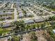 A neighborhood view with single-story homes featuring gray roofs and landscaping in a quiet residential area at 667 Foxwood Blvd, Englewood, FL 34223