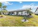 Backyard featuring well-maintained lawn and patio with seating at 667 Foxwood Blvd, Englewood, FL 34223