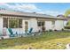 Backyard featuring well-maintained lawn and patio with seating at 667 Foxwood Blvd, Englewood, FL 34223