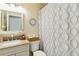 Neutral bathroom featuring granite counters, decorative shower curtain and a decorative clock at 667 Foxwood Blvd, Englewood, FL 34223