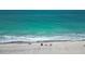 Scenic beach scene with turquoise water, soft sand, and a few people enjoying a relaxing day by the ocean at 667 Foxwood Blvd, Englewood, FL 34223