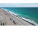Expansive beach featuring turquoise water, a sandy shoreline with beachgoers, and clear skies, a perfect relaxing scenery at 667 Foxwood Blvd, Englewood, FL 34223