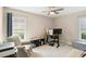 Bedroom with plush carpeting, bright windows, and a ceiling fan at 667 Foxwood Blvd, Englewood, FL 34223