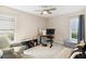 Bedroom with plush carpeting, bright windows, and a ceiling fan at 667 Foxwood Blvd, Englewood, FL 34223
