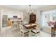 Dining room with a wooden table, chairs, chandelier, and a view into the kitchen at 667 Foxwood Blvd, Englewood, FL 34223