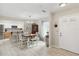 Bright dining room featuring wood floors, a chandelier, and an adjacent kitchen at 667 Foxwood Blvd, Englewood, FL 34223