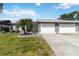 Well-maintained home with a two-car garage, neat landscaping, a stone-lined flower bed, and charming curb appeal at 667 Foxwood Blvd, Englewood, FL 34223