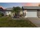 Charming single-story home features a well-manicured lawn, lovely landscaping, and an attached two-car garage at 667 Foxwood Blvd, Englewood, FL 34223